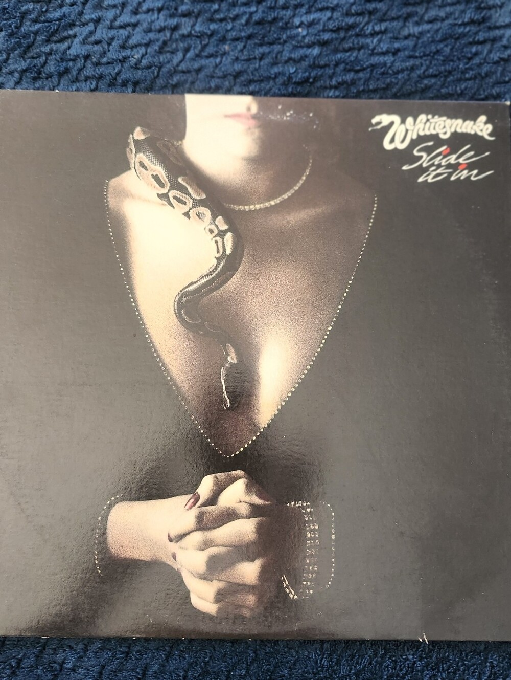 1984 vinyl album cover for Slide It In by the hard rock band Whitesnake.